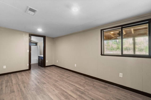 spare room featuring wood-type flooring