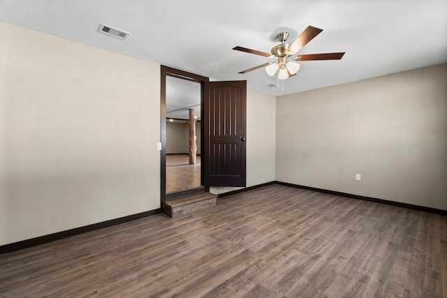 spare room with ceiling fan and dark hardwood / wood-style floors