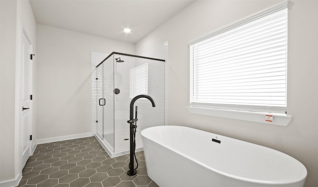 bathroom featuring tile patterned flooring and independent shower and bath