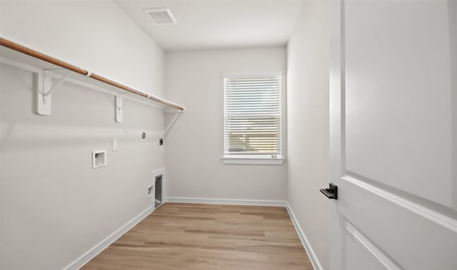 clothes washing area with washer hookup, hookup for a gas dryer, light hardwood / wood-style flooring, and electric dryer hookup