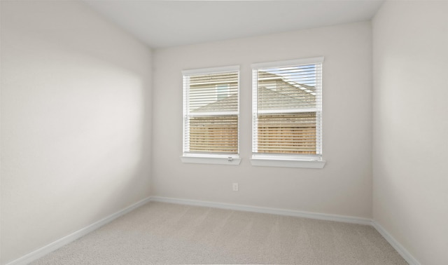 spare room featuring light colored carpet