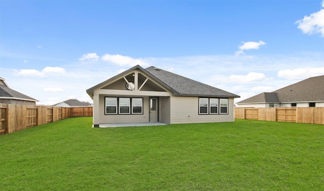 back of property with a lawn and a patio