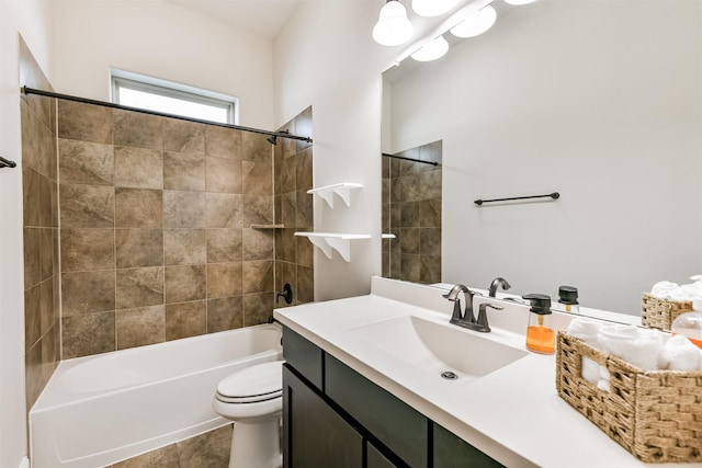 full bathroom featuring toilet, tiled shower / bath combo, and vanity