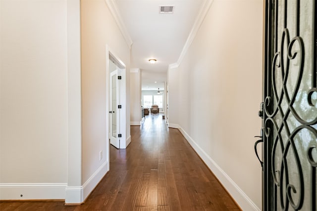 corridor featuring crown molding and dark hardwood / wood-style floors