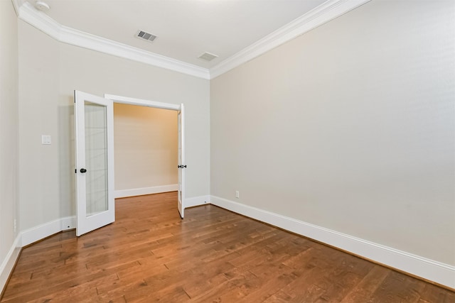 unfurnished room featuring hardwood / wood-style flooring, ornamental molding, and french doors