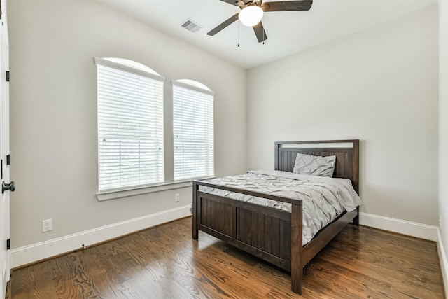 bedroom with ceiling fan and dark wood-type flooring