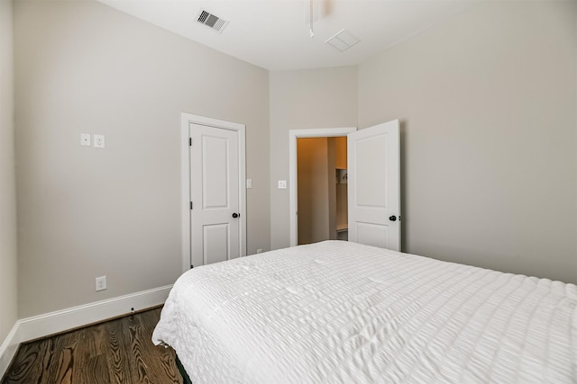 bedroom with dark wood-type flooring