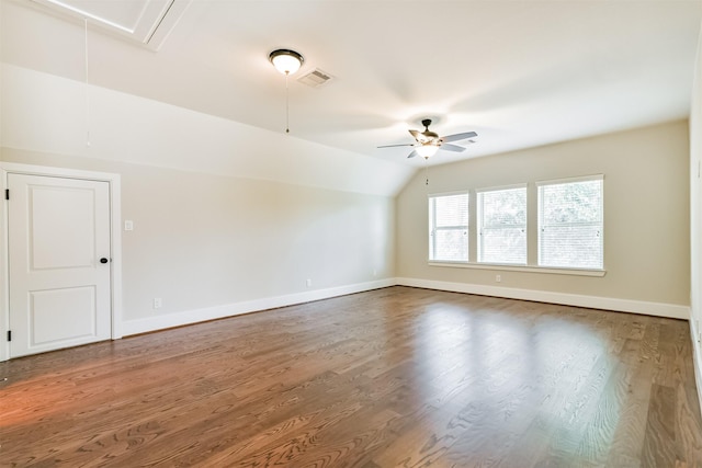 spare room featuring ceiling fan, wood-type flooring, and vaulted ceiling