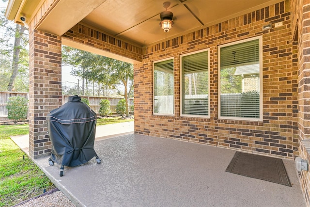 view of patio featuring ceiling fan and a grill