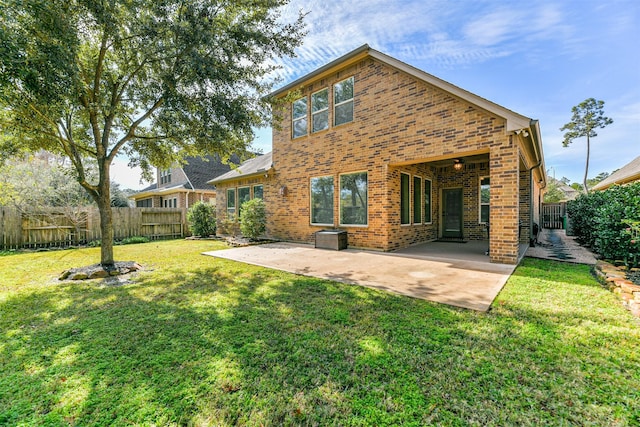 back of house featuring a yard and a patio