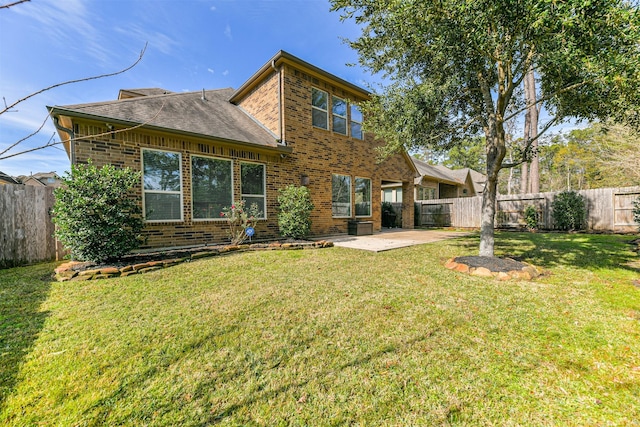 back of property featuring a lawn and a patio