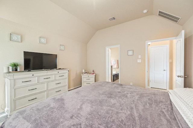 unfurnished bedroom featuring light carpet, ensuite bath, and vaulted ceiling