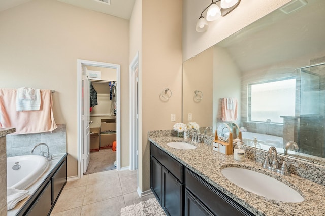 bathroom featuring vanity, independent shower and bath, and tile patterned flooring