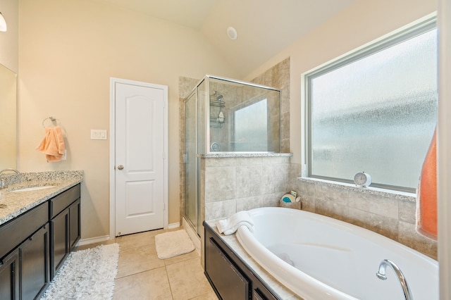 bathroom with lofted ceiling, tile patterned floors, separate shower and tub, and vanity