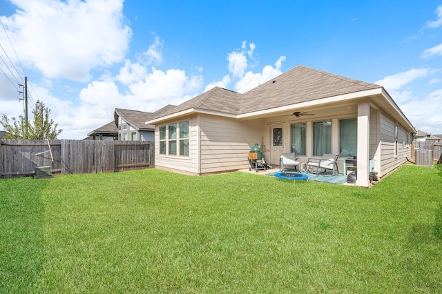 rear view of property featuring ceiling fan, outdoor lounge area, a lawn, and a patio