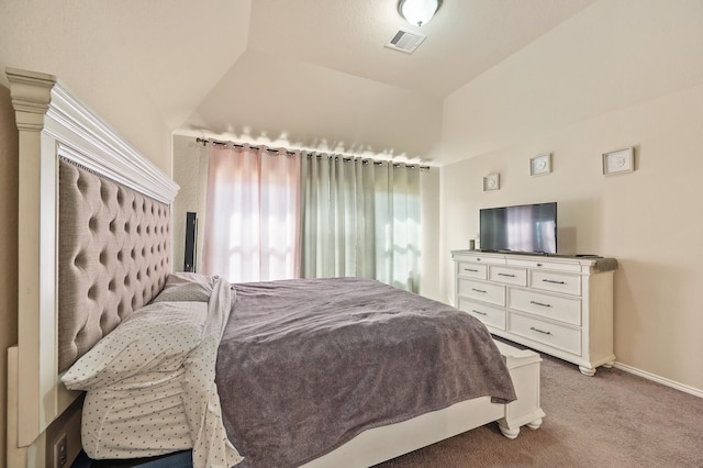 bedroom featuring lofted ceiling and light carpet