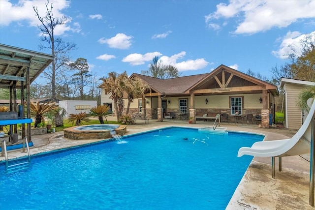 view of swimming pool with an in ground hot tub, a patio area, a water slide, and pool water feature