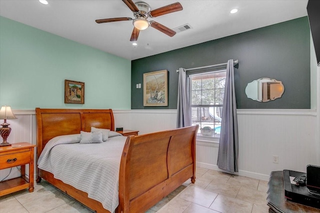 tiled bedroom featuring ceiling fan