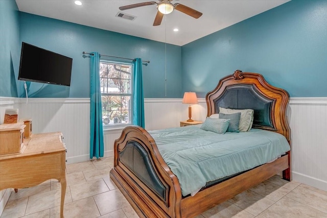 tiled bedroom featuring ceiling fan