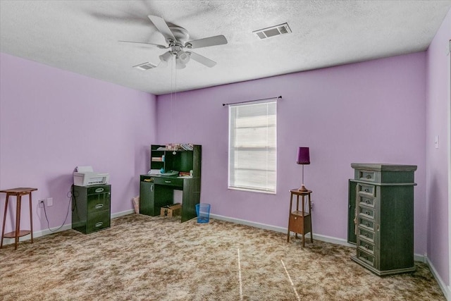 misc room with a textured ceiling, ceiling fan, and carpet