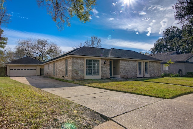 ranch-style home featuring a garage and a front yard