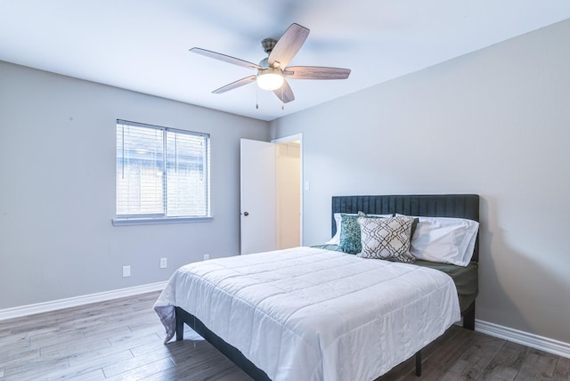 bedroom with ceiling fan and hardwood / wood-style flooring