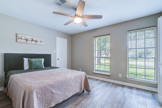 bedroom with ceiling fan and hardwood / wood-style flooring