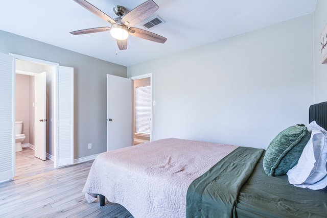 bedroom with ceiling fan, connected bathroom, and light hardwood / wood-style floors