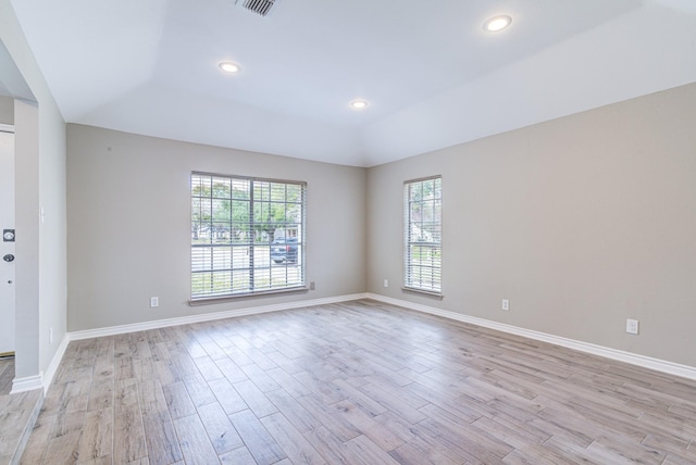 unfurnished room with a wealth of natural light and light hardwood / wood-style flooring