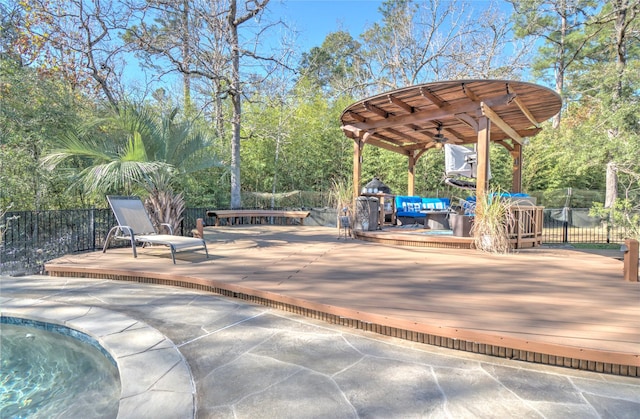 view of patio / terrace featuring ceiling fan and a swimming pool side deck