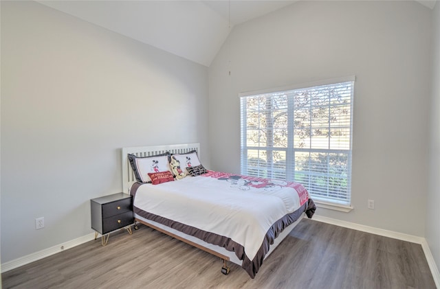 bedroom with vaulted ceiling and wood-type flooring