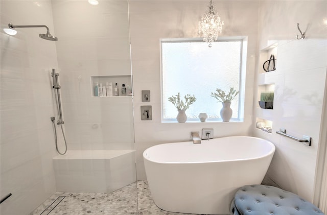 bathroom featuring a chandelier and plus walk in shower