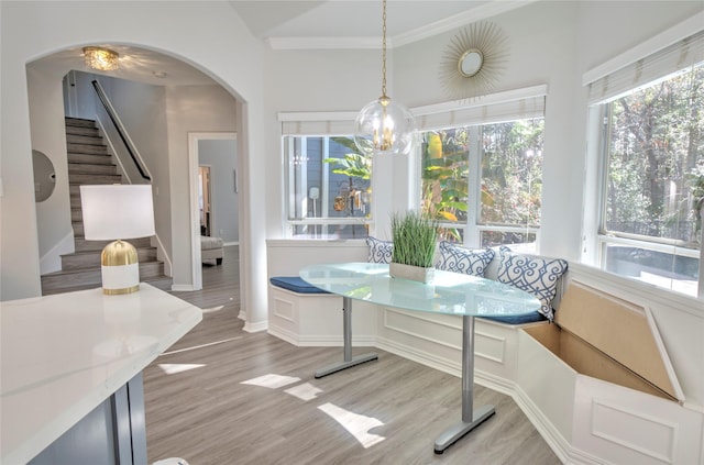 dining area featuring light hardwood / wood-style flooring, vaulted ceiling, and breakfast area