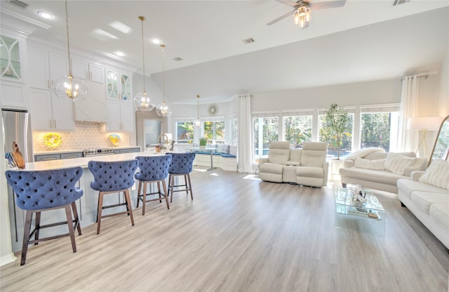 living room featuring ceiling fan and light hardwood / wood-style flooring