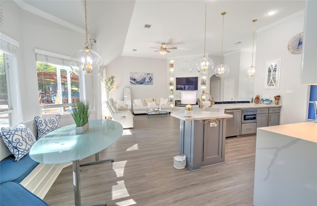 kitchen featuring ceiling fan, stainless steel dishwasher, hanging light fixtures, and gray cabinets