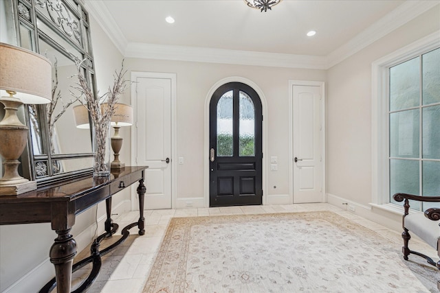 tiled foyer featuring crown molding