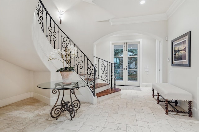 entryway featuring ornamental molding and french doors