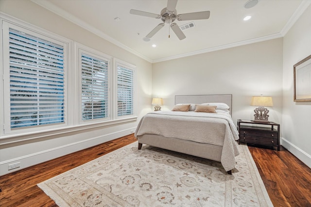 bedroom featuring ceiling fan, dark hardwood / wood-style flooring, and crown molding