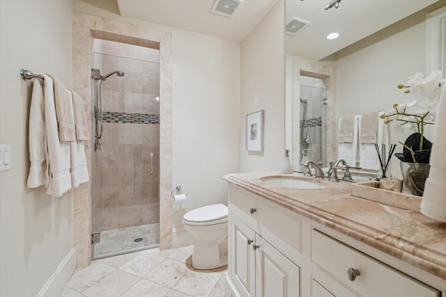 bathroom with a shower with door, toilet, vanity, and tile patterned flooring