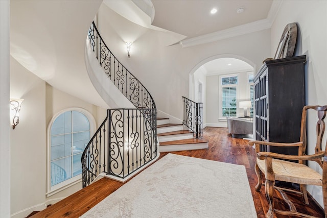 entryway featuring dark hardwood / wood-style floors and crown molding