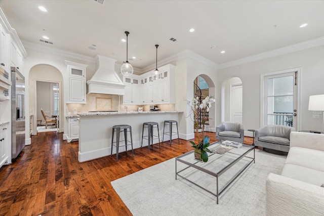 living room featuring dark hardwood / wood-style flooring and crown molding