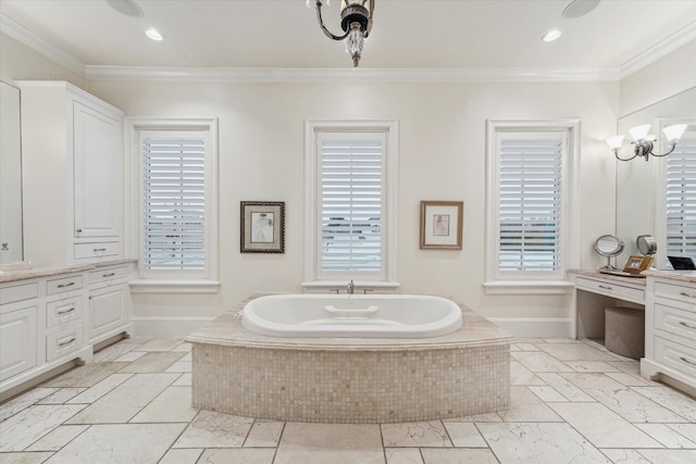 bathroom featuring tiled bath, ornamental molding, plenty of natural light, and vanity