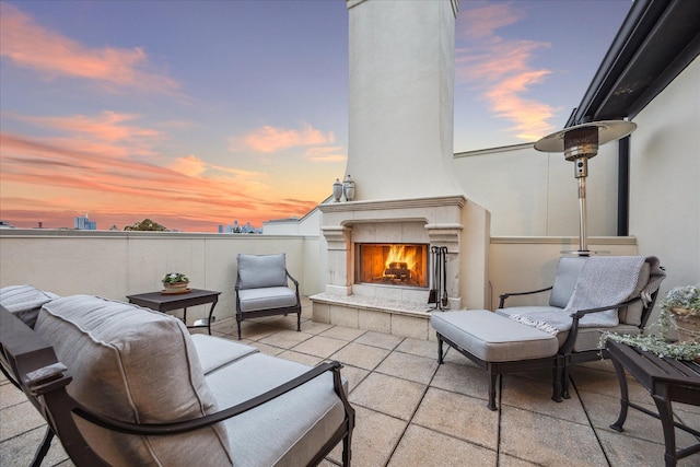 patio terrace at dusk with a fireplace