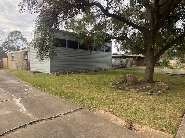 view of side of home featuring a yard