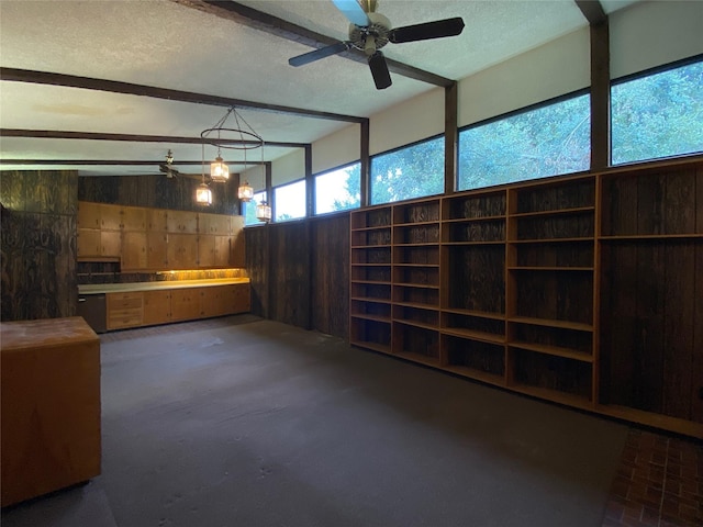 interior space with ceiling fan and wooden walls