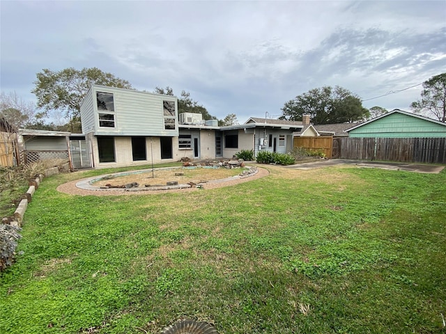 back of property with a lawn