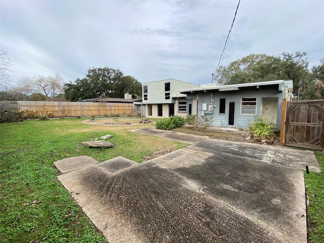 rear view of house featuring a lawn