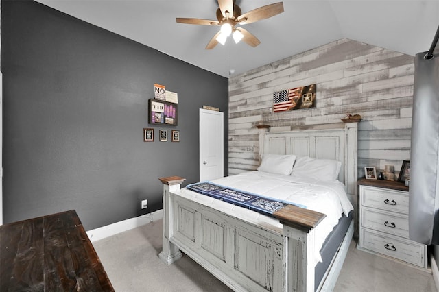 bedroom featuring ceiling fan, light colored carpet, lofted ceiling, and wood walls