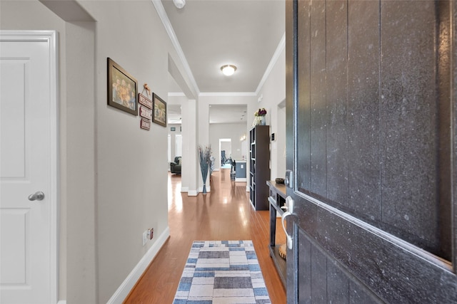 hall with dark hardwood / wood-style flooring and ornamental molding