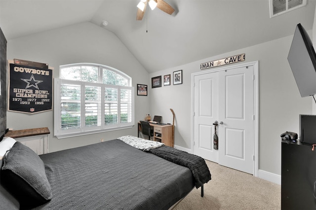 carpeted bedroom featuring ceiling fan, a closet, and vaulted ceiling